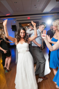 bride and guests having fun on dance floor with wedding guests