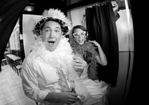 couple in photo booth with silly hats and funny faces