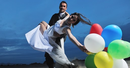 wedding bride and groom surprising guests with balloons